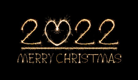 Happy New Year 2022 text hand written sparkles fireworks with Colorful fireworks of various colors...