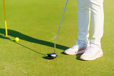 Golfer preparing for a putt Golf ball on the green during golfcourse.の写真素材