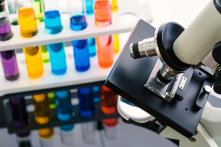 scientist with equipment and science experiments, laboratory glassware containing chemical liquid...