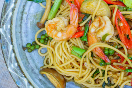 Spicy spaghetti with prawns seafood and basil in the dish.の写真素材