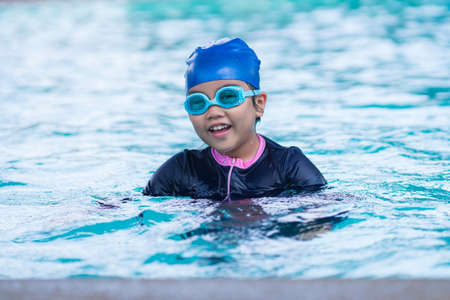 happy children Smiling cute little girl in sunglasses in swimming pool.