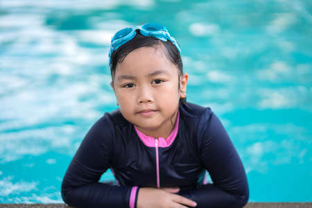 happy children Smiling cute little girl in sunglasses in swimming pool.