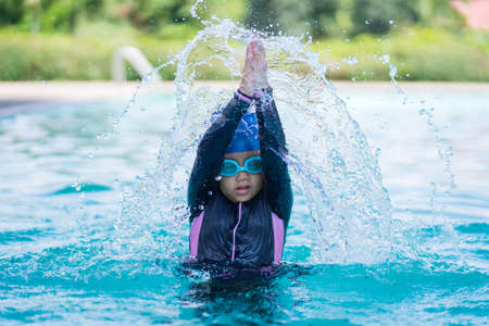 happy children Smiling cute little girl in sunglasses in swimming pool.の写真素材