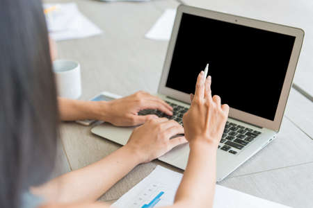 Business girls looking at laptop for presenting or discussing together in conference room during...
