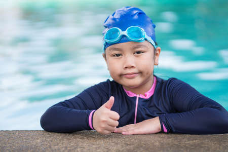 happy children Smiling cute little girl in sunglasses in swimming pool.の写真素材