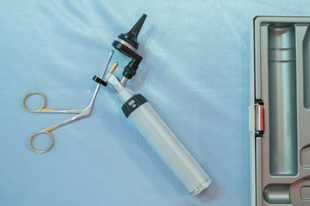 ENT physician checking patient's ear using otoscope with an instrument.の写真素材