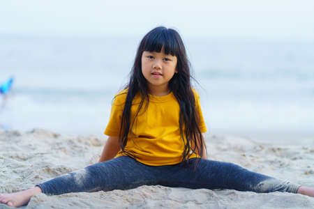 Child playing sand beach, on the beach on summer holidays. Children building a sandcastle at sea.の写真素材