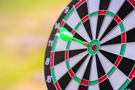 bullseye target or dartboard has arrow throw hitting the center of a shooting, concept of business targeting and winning goals.の写真素材