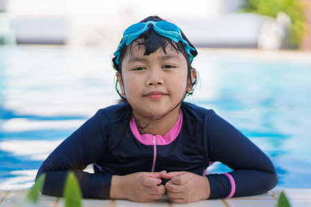 happy children Smiling cute little girl in sunglasses in swimming pool.の写真素材