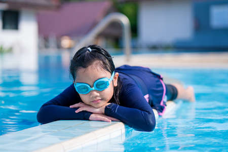 happy children Smiling cute little girl in sunglasses in swimming pool.の写真素材