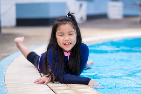 happy children Smiling cute little girl in sunglasses in swimming pool.の写真素材