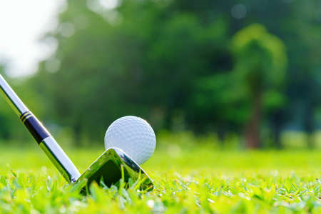 Golf ball on green grass ready to be struck on golf course.の写真素材