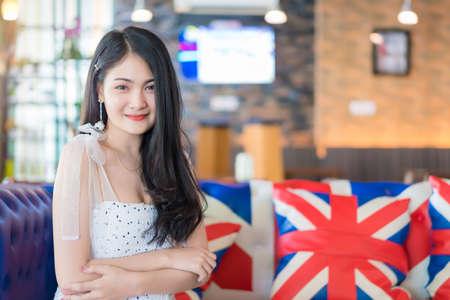 Portrait of woman smiling at vintage restaurant cafe.の写真素材