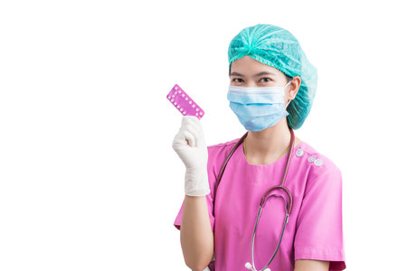 Female doctor holding birth control pills. Contraceptives in hands for safe sex, concept of pharmacist, drugs, diet pill, antibiotic or vitaminの写真素材