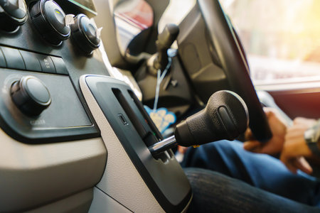 man driving a car and shifting gears on the gearbox.の写真素材