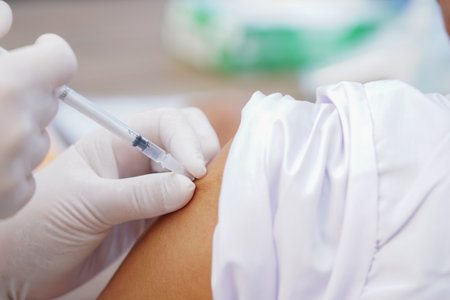 Nurse holding a syringe for the injection giving patient vaccine in hospital. Health care Concept.の写真素材