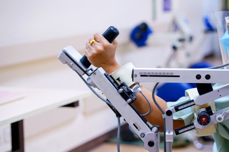 woman wear machine arm for physical therapy. By defining how a robot driven moving technique can be improved to achieve better results in physical rehabilitation.の写真素材
