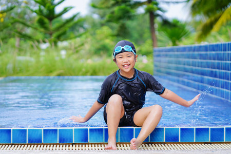happy children Smiling cute little girl in sunglasses in swimming poolの写真素材