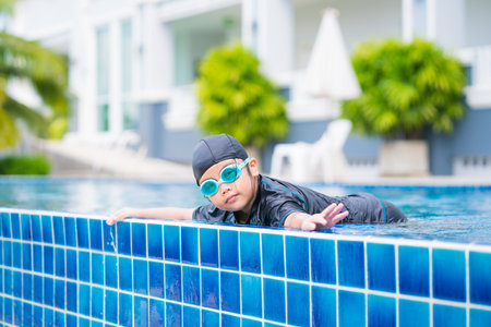 happy children Smiling cute little girl in sunglasses in swimming poolの写真素材