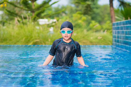 happy children Smiling cute little girl in sunglasses in swimming pool.の写真素材
