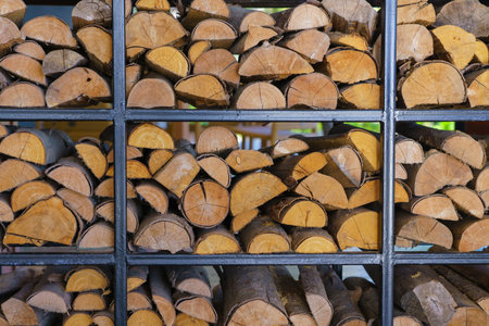 Firewood stacked up in a pile for abstract background.の写真素材