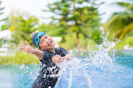 happy children Smiling cute little girl in sunglasses in swimming poolの写真素材