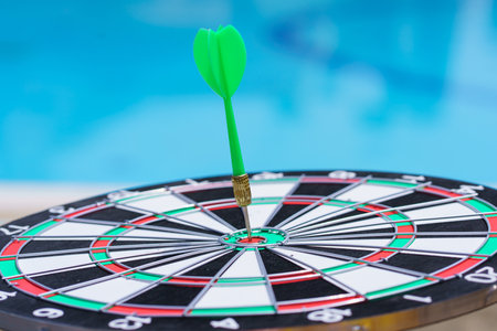 bullseye target or dartboard has arrow throw hitting the center of a shooting, concept of business targeting and winning goals.の写真素材