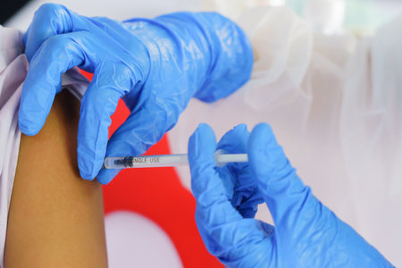 Nurse holding a syringe for the injection giving patient vaccine in hospital. Health care Concept.の写真素材