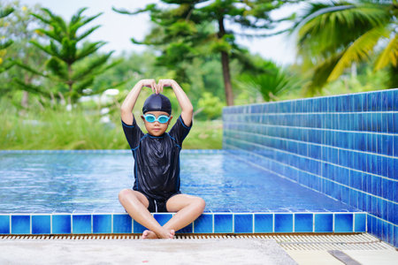 happy children Smiling cute little girl in sunglasses in swimming pool.
