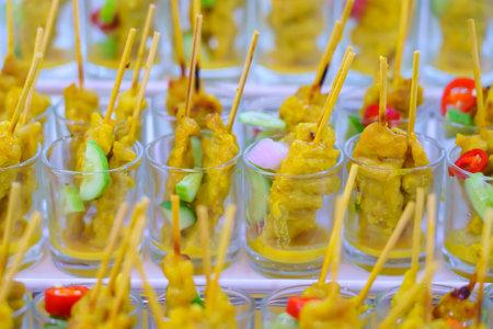 Pork satay or Grilled pork in a cocktail glass served with peanut sauce or sweet and sour sauce.の写真素材