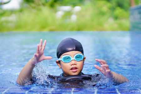 happy children Smiling cute little girl in sunglasses in swimming pool.の写真素材