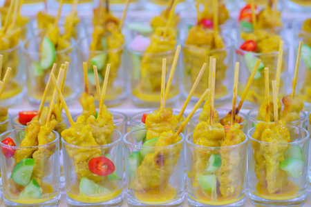 Pork satay or Grilled pork in a cocktail glass served with peanut sauce or sweet and sour sauce.の写真素材