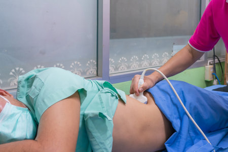Closeup of man getting an ultrasound scan on abdominal by doctor.