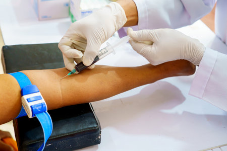 Nurse collecting a blood from patient in hospital.