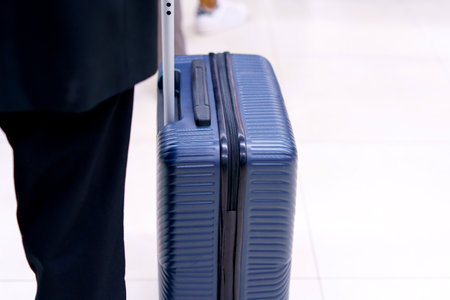 Businessman drag luggage or suitcase walking in airport terminal for air transport and traveling theme.の写真素材