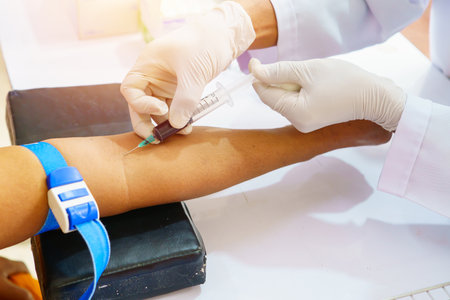 Nurse collecting a blood from patient in hospital.の写真素材