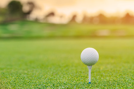 Golf ball on tee ready to be shot at golfcourt.の写真素材