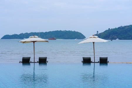 sunbed near swimming pool at the hotel.の写真素材