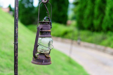 Vintage lamp on footpath with green meadow fieldの写真素材