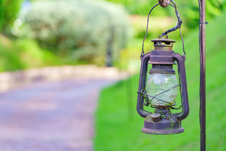 Vintage lamp on footpath with green meadow fieldの写真素材