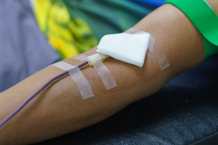 man as blood donor at donation with a bouncy ball holding in hand.の写真素材