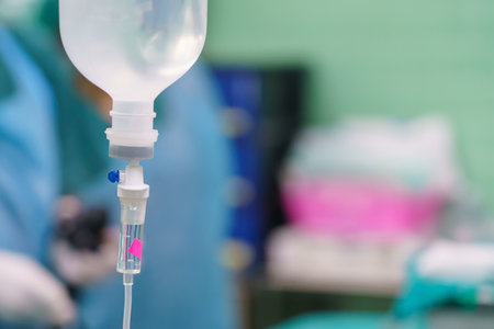 Normal saline solution or sodium chloride with infusion bottle drip for patient in hospital, Intravenous system of operating surgeons.の写真素材