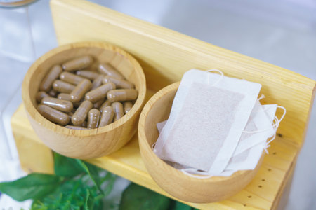 herbal capsule in wooden cup with herbal tea for spa treatment or relaxation.の写真素材