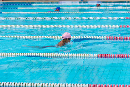 child swimmer swim in swimming pool. Water sports and competition, learning to swim classes for children.の写真素材