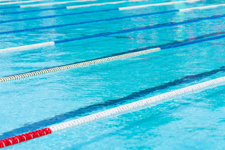 competition pool with blue water and marked swimming lanes.の写真素材