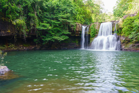 Klong Chao waterfall serenely cascades and green water below in Koh Kood island, Thailandの写真素材
