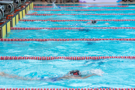 child swimmer swim in swimming pool. Water sports and competition, learning to swim classes for children.の写真素材