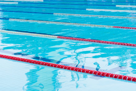 competition pool with blue water and marked swimming lanes.の写真素材