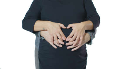 Mixed Race Couple Heart Symbol Valentines Arms Locked Around Pregnant Bellyの写真素材