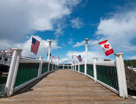 Roche Harbor - United States of America and Canada Flags Hang From the Dockの写真素材